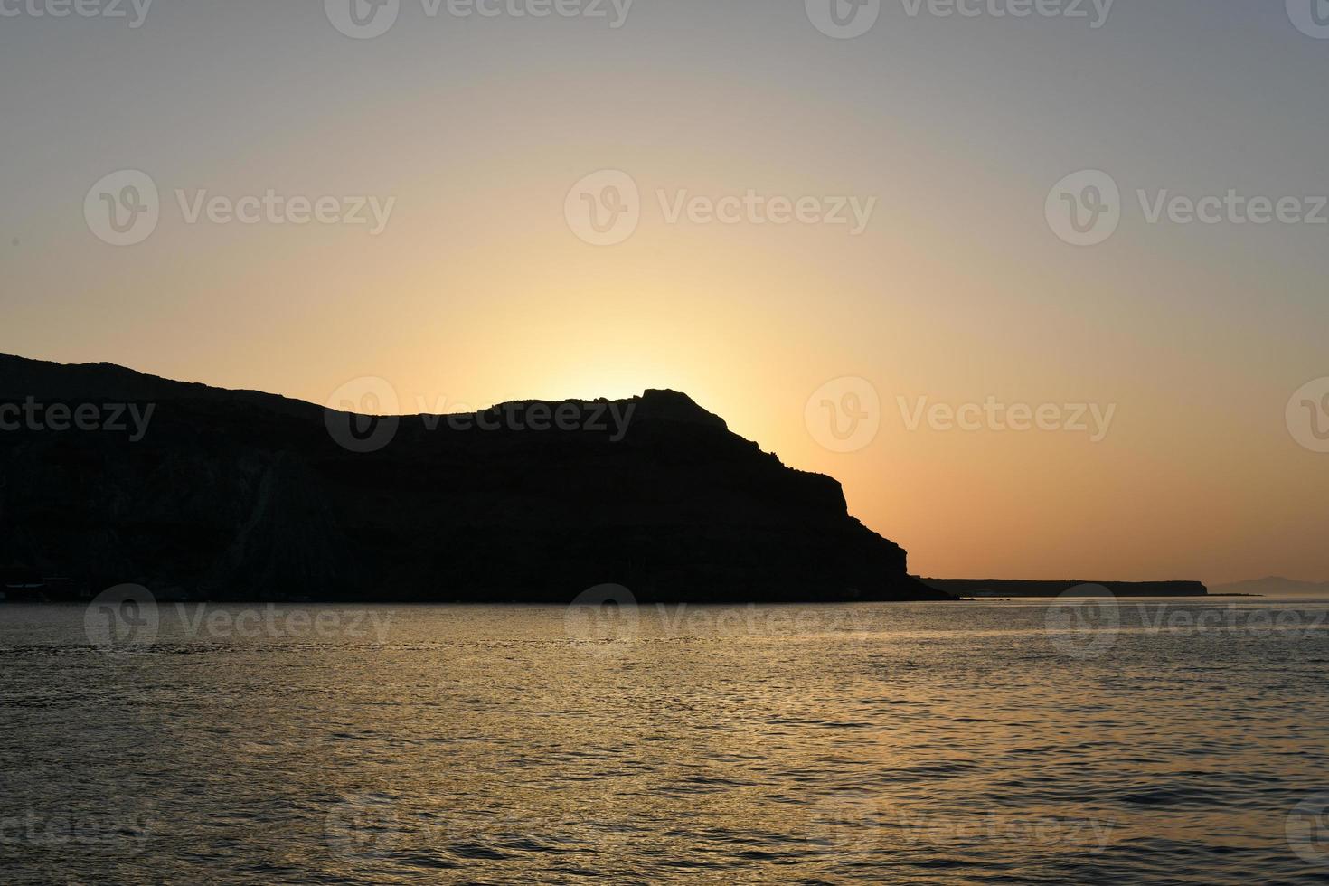 Sunset over the cliffs of Thirasia in the caldera of Santorini, Cyclades islands, Greece, Europe photo
