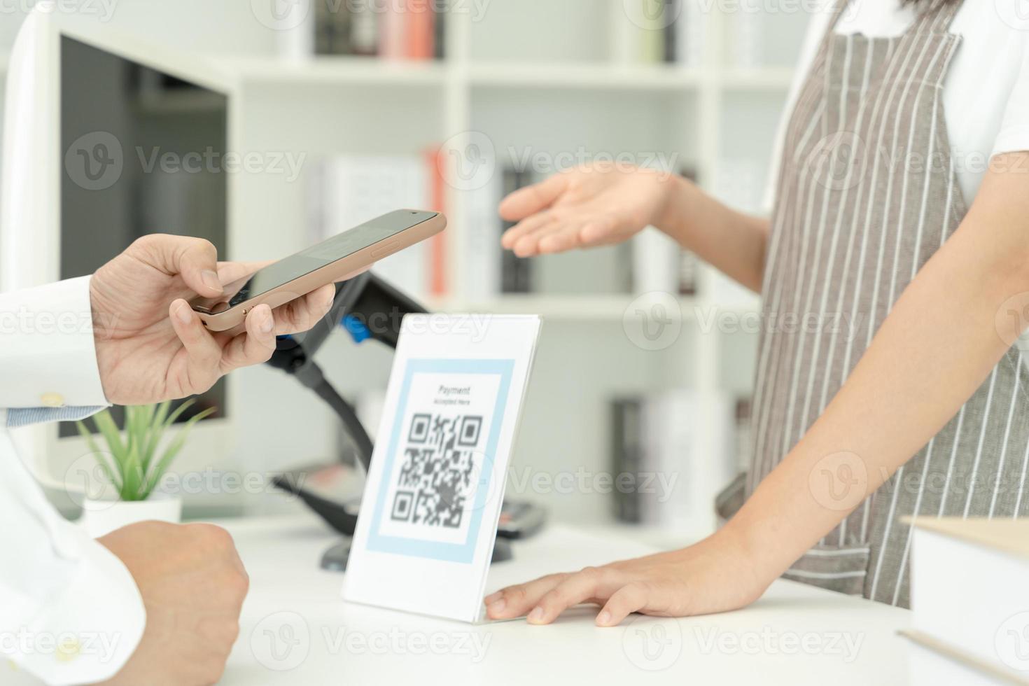 Customer use smartphones to scan QR codes to pay in-store with digital payments without cash. scanning get discounts. E wallet, technology, online payment, banking app, smart city, money transfer. photo
