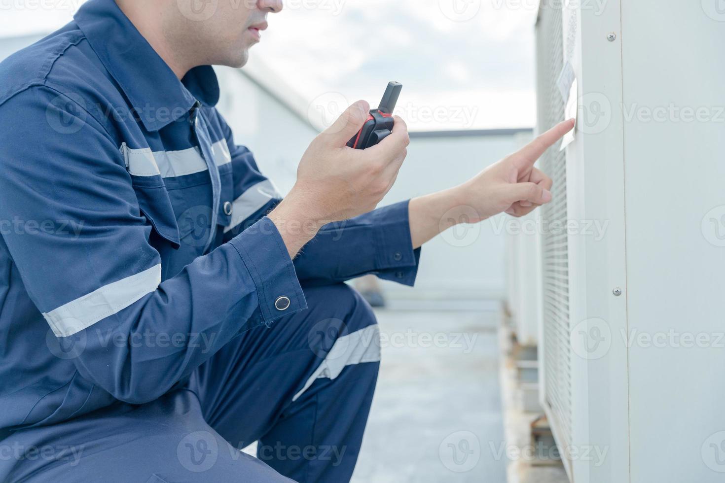 maintenance engineer works on the roof of factory. contractor inspect compressor system and plans installation of air condition systems in construction. technology, online checking photo