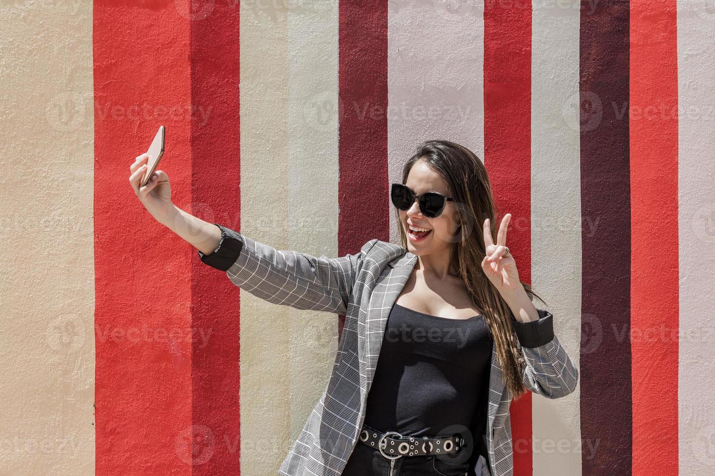 Happy woman taking selfie in city photo