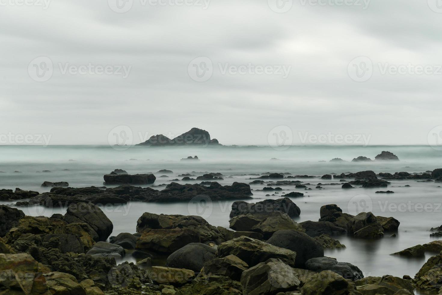 The Campiecho beach is located in Asturias, Spain on a cloudy day. photo