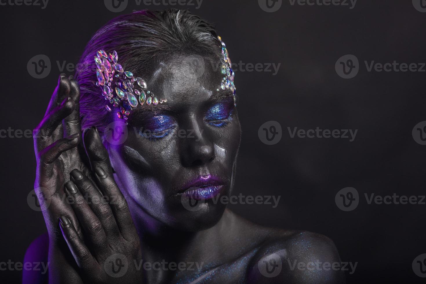 Nice woman with creative makeup on her face photo