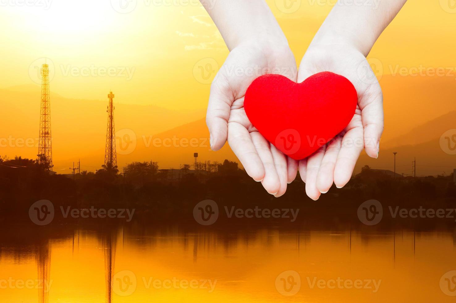 Close up Red heart in woman hands, isolated on industry energy landscape background,health, medicine, people and cardiology concept,energy concept photo