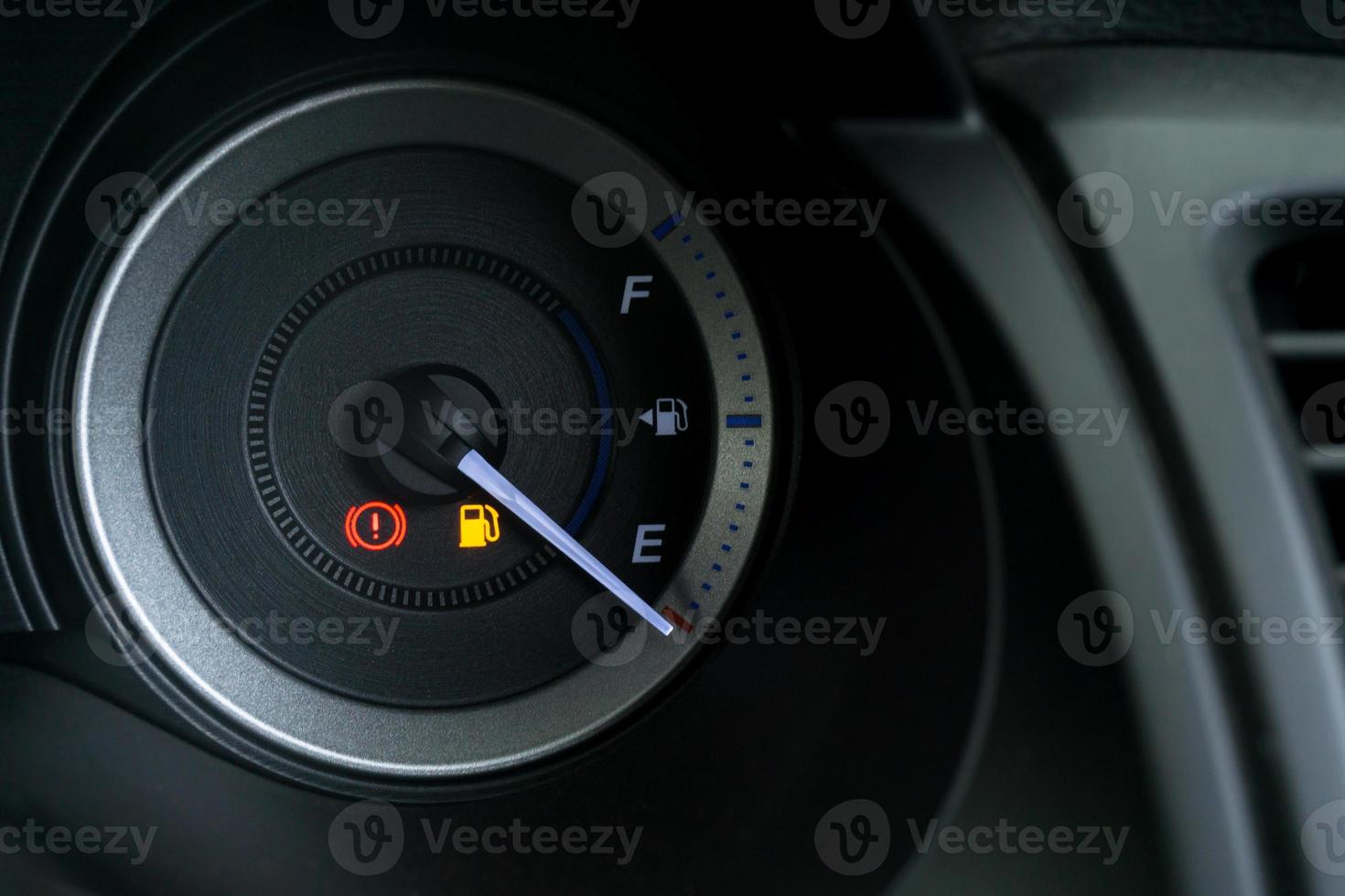 Detail with the fuel gauges showing and empty tank on dashboard of car photo