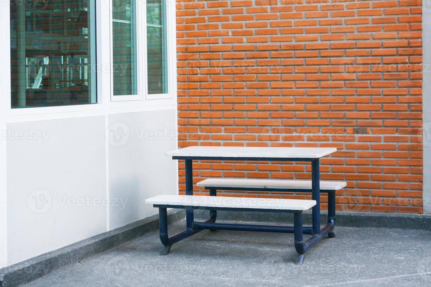 Bench in front of a brick wall blocks at modern building photo