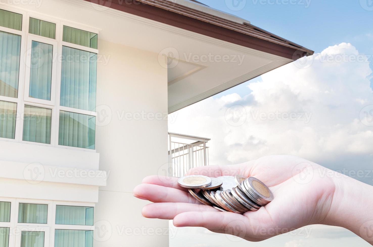 Coins in hands money Savings and apartment ,condominium,house,home photo