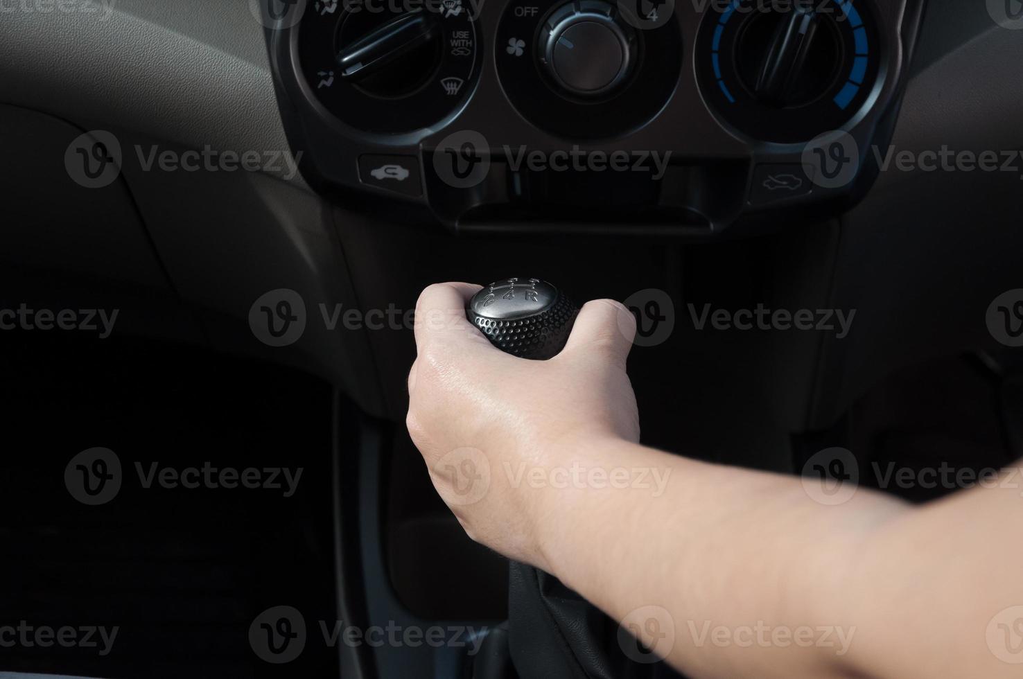 Driver hand shifting the gear stick,Hand on car gear knob.The driver switches the speed in the car. Hand on gear lever. photo