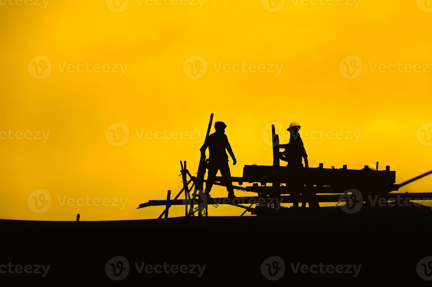 Silhouette of engineer and construction team working at site for industry background,Workers are working silhouette photo