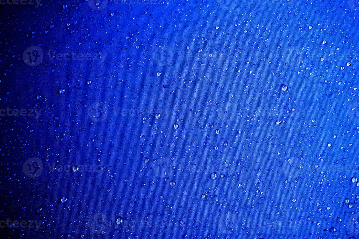 Water drops on the blue fabric.water drops on blue background photo