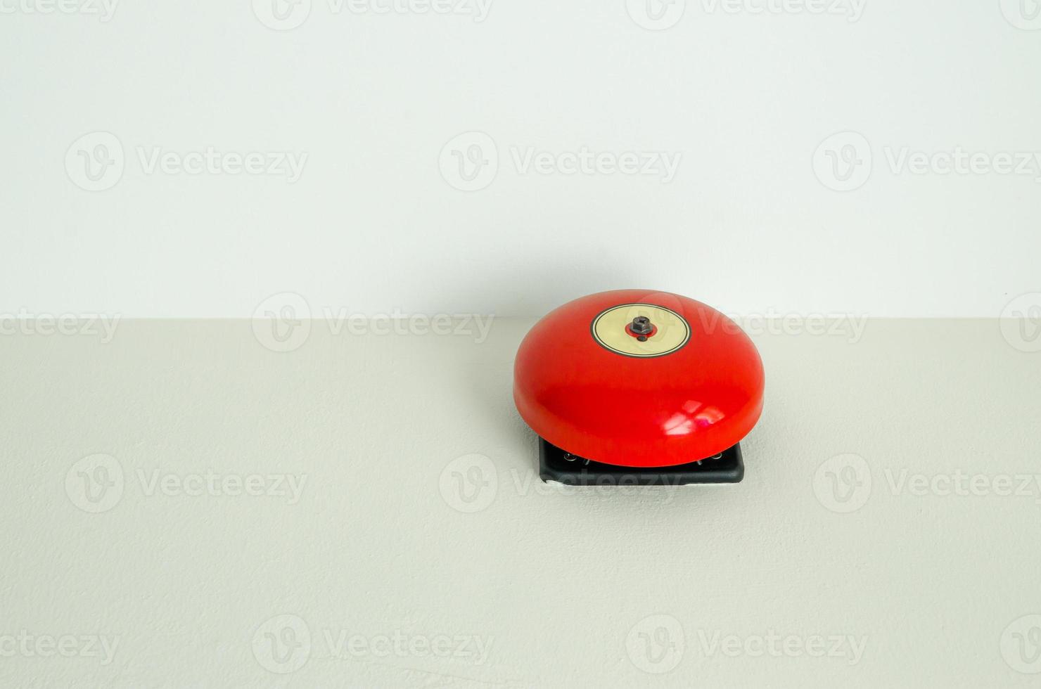 Red fire alarm  on wall photo