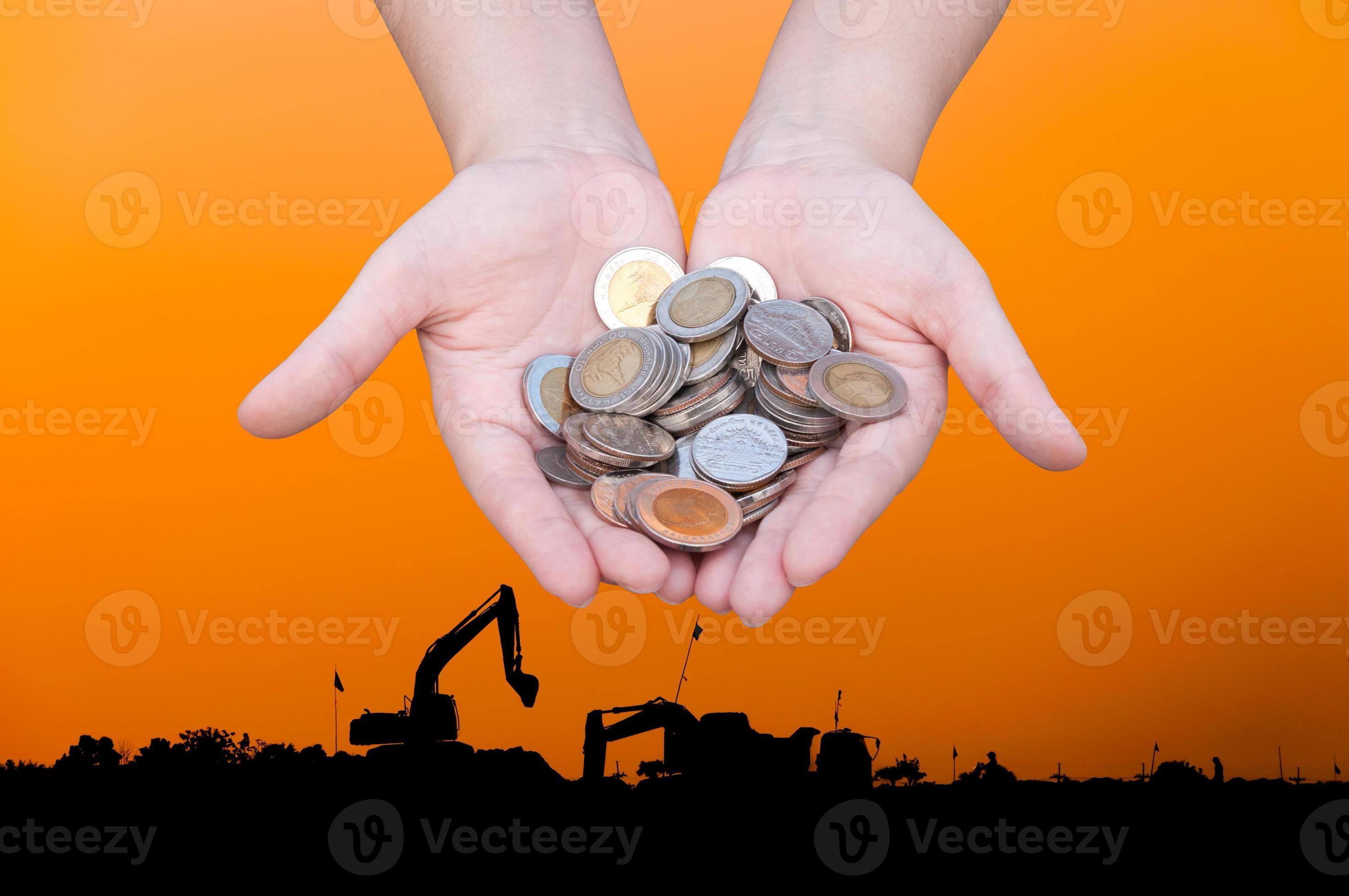 Coins in hands on Industry silhouette Landscape background,Donation