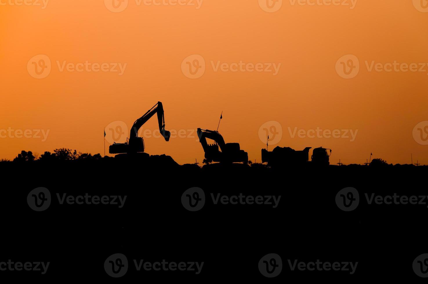 silhouette of excavator loader at construction site,Silhouette Backhoe,track-type loader excavator machine doing earthmoving photo