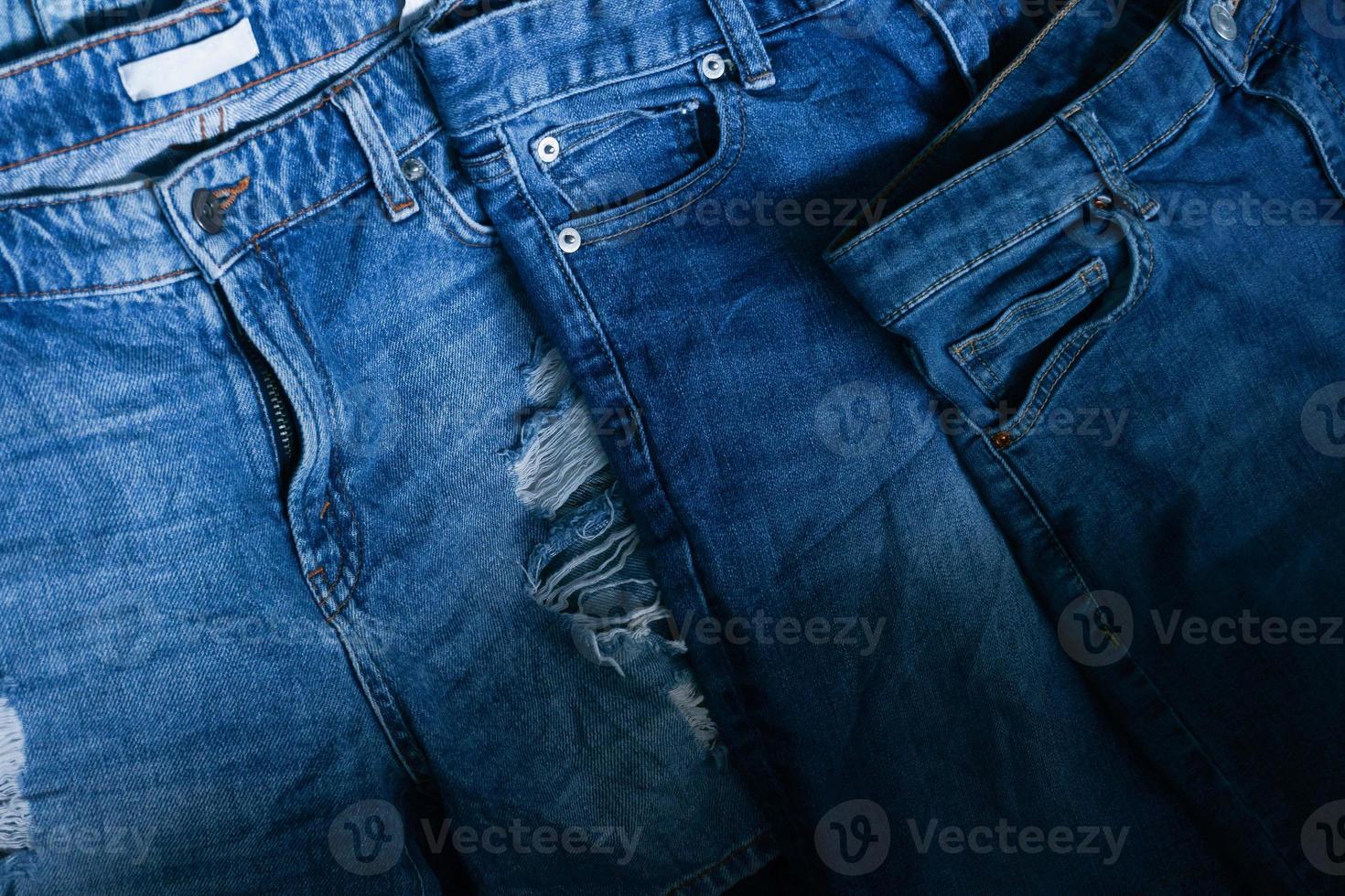 Stack of various shades blue jeans. Pile Blue denim jeans texture banner. Canvas denim fashion texture photo