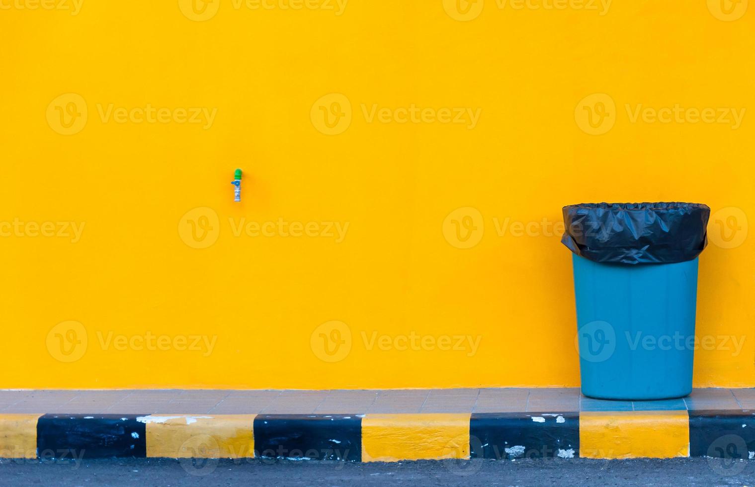 Garbage bin on barckground wall yellow photo