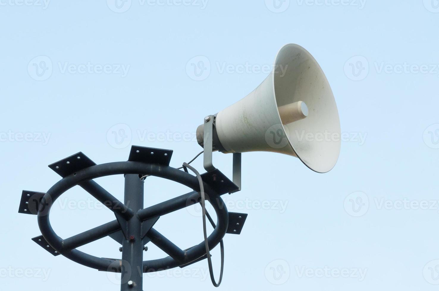 White megaphone on the old pole photo