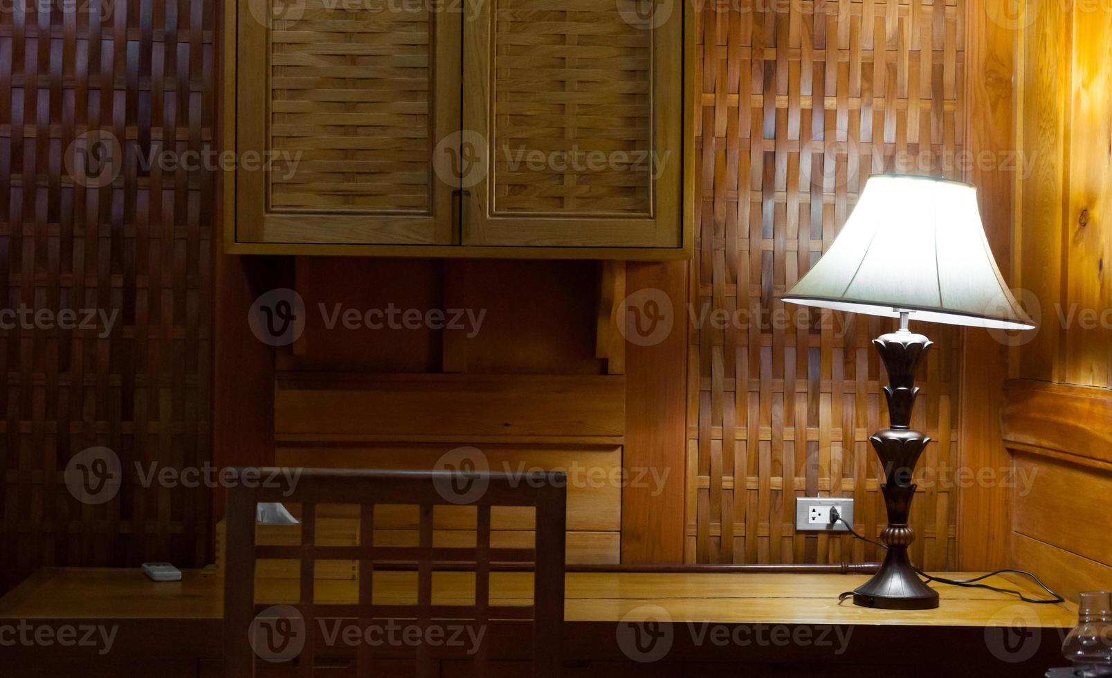 Elegant lamp in warm interior room,Turned On Old Lamp near the wooden wall photo