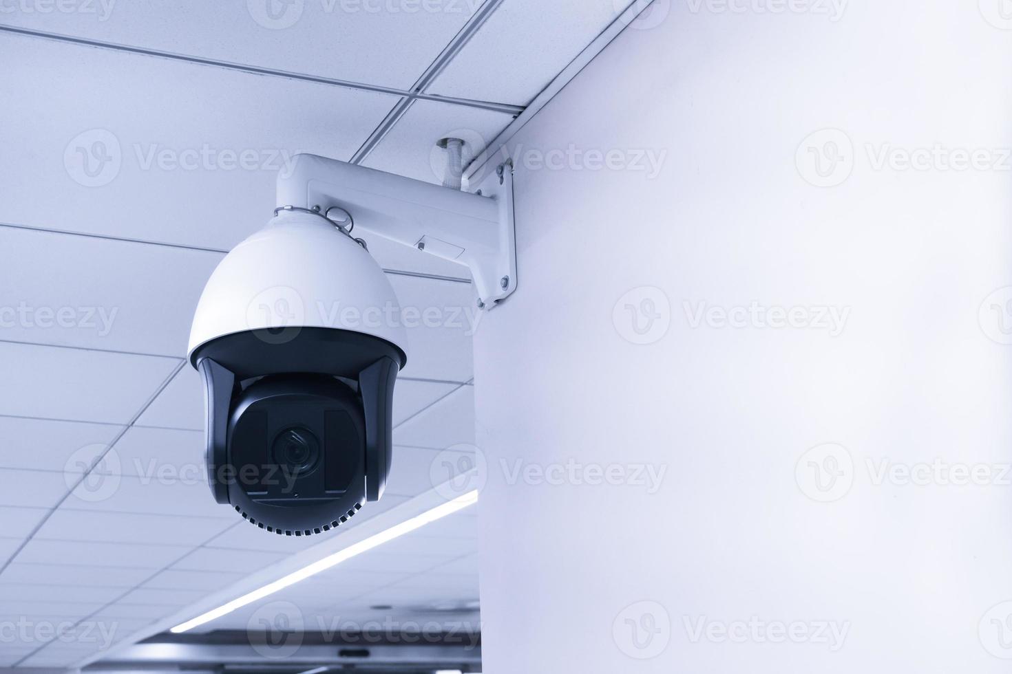 Security CCTV camera or surveillance system in building ,Closed-circuit television,Modern CCTV camera on a wall. photo