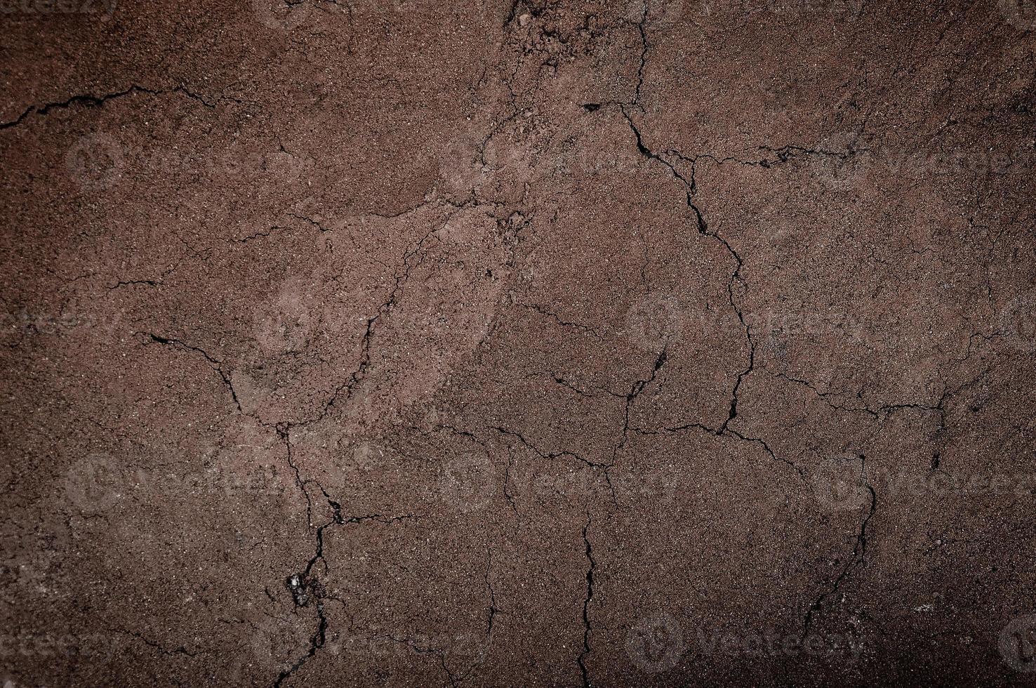 Cracked and barren ground,dry soil textured background,form of soil layers,its colour and textures,texture layers of earth for background photo