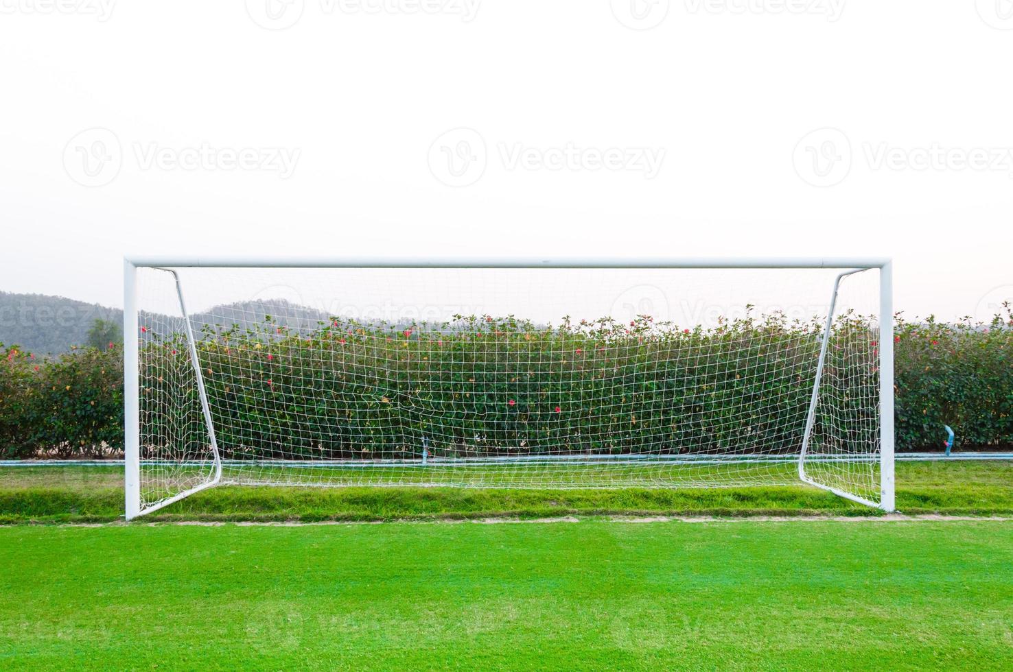 Goal shot from the corner in the front ,soccer field,empty amateur football goal posts and nets photo