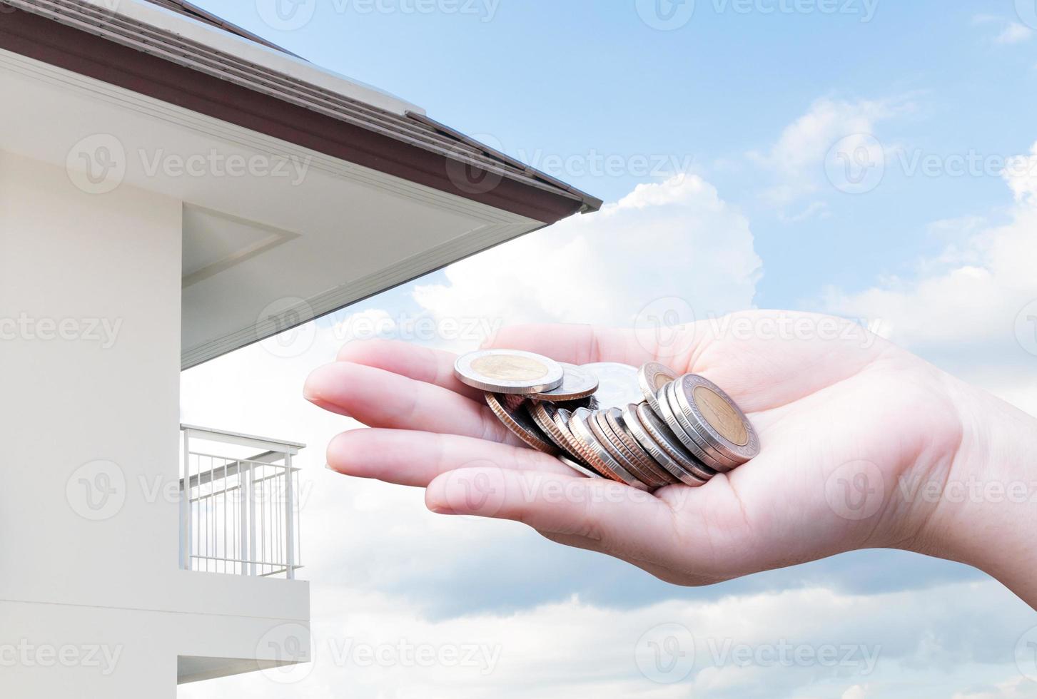 Coins in hands money Savings and apartment ,condominium,house,home photo