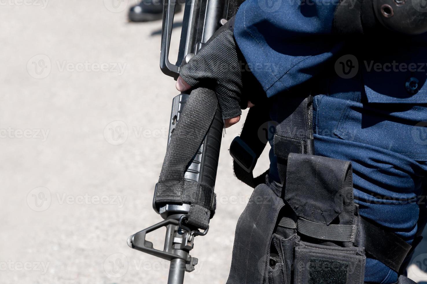 Soldier holding a machine with automatic gun.Preparation for military action.Soldier dressed in protective equipment photo