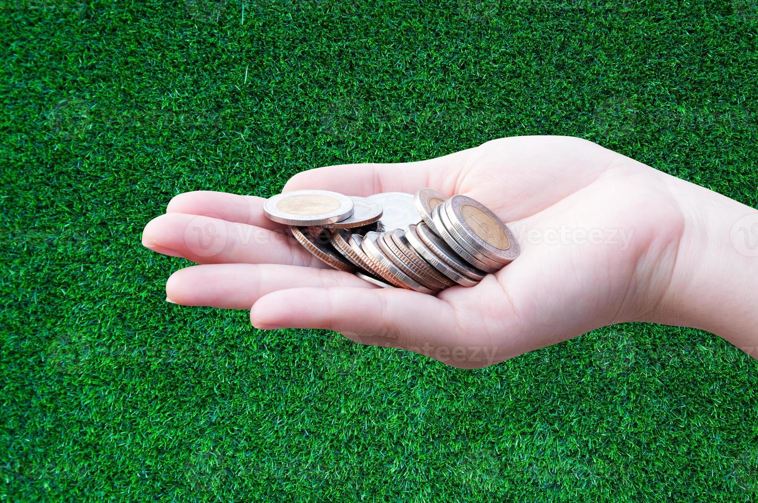 Coins in hands on grass,Donation Investment Fund Financial Support Charity  Dividend Market Growth Home House Stock Trust Wealthy Giving Planned Accounting Collection Debt Banking ROI concept photo