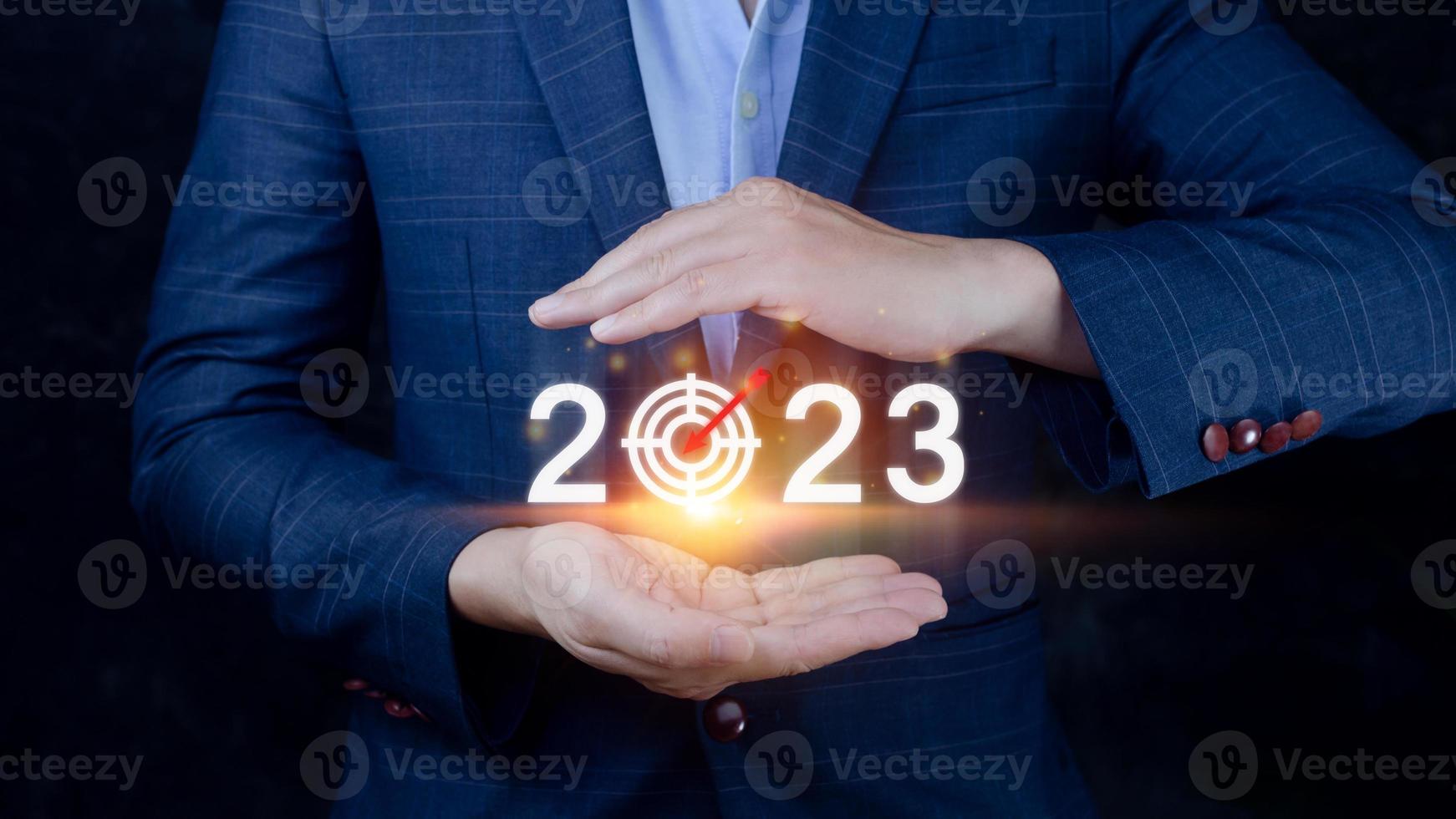 Business target and goal 2023 icon, hand pointing holding 2023 virtual screen, Start new year 2023 with a goal plan, action plan, strategy, new year business vision. photo