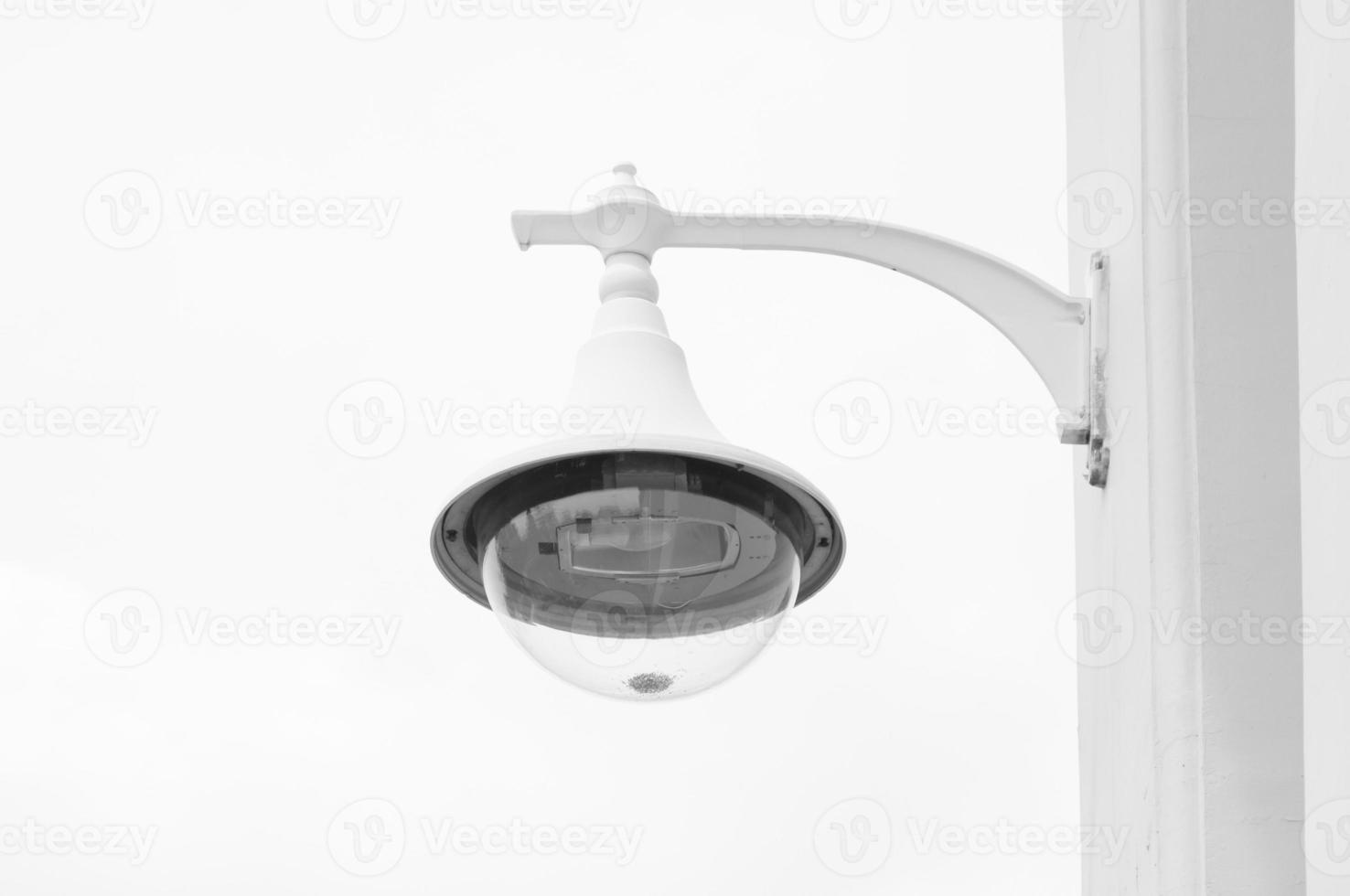 Lamppost on a white background,classic white wall lamp,retro with a lamp shade and a bulb photo