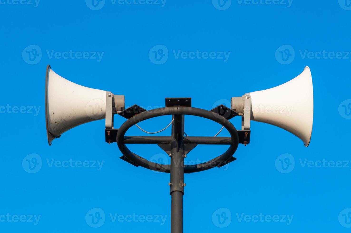 White megaphone on the old pole and bluesky photo