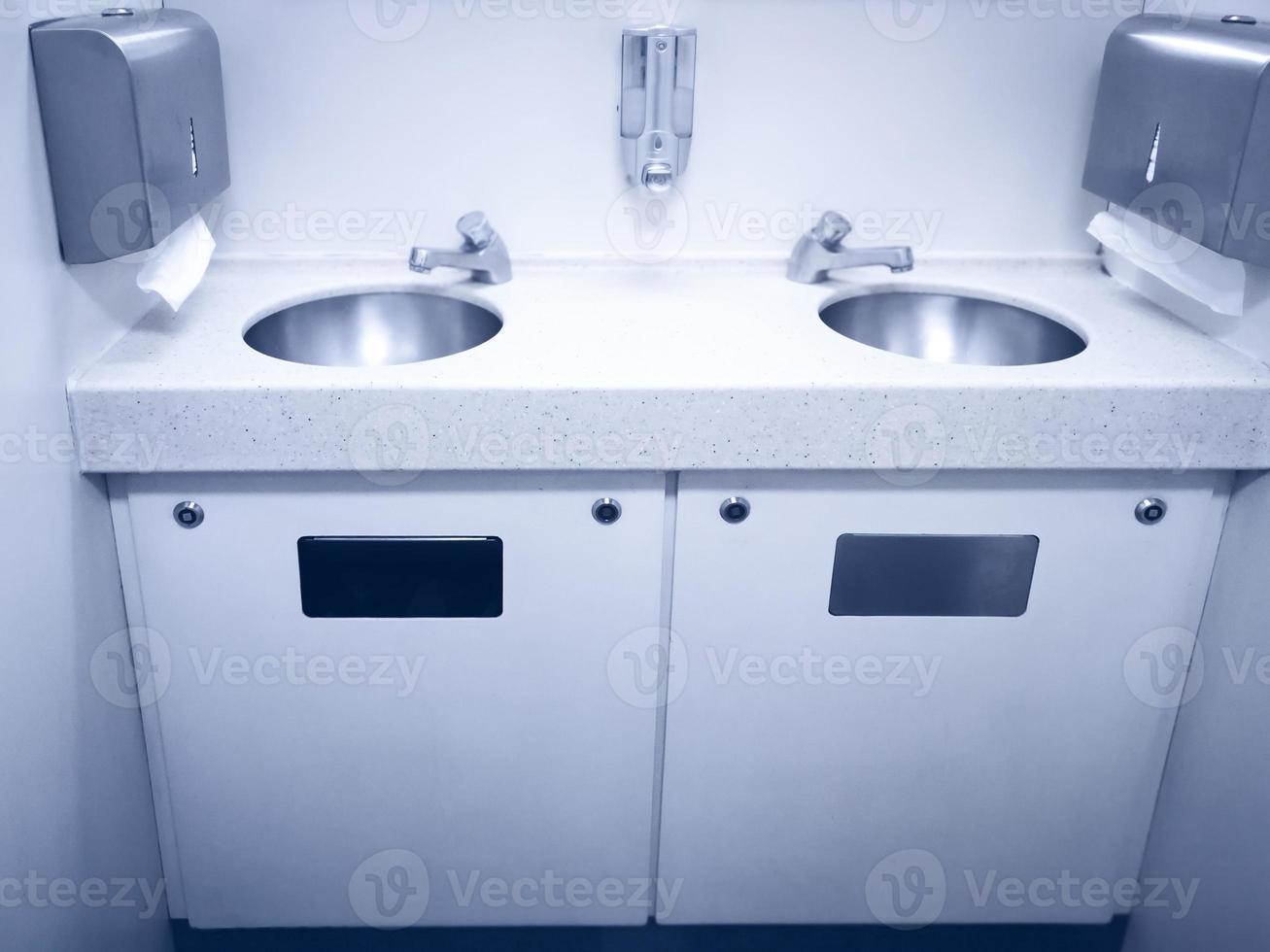 Sink wash hands and toilet paper clean of the train in a fast modern train photo