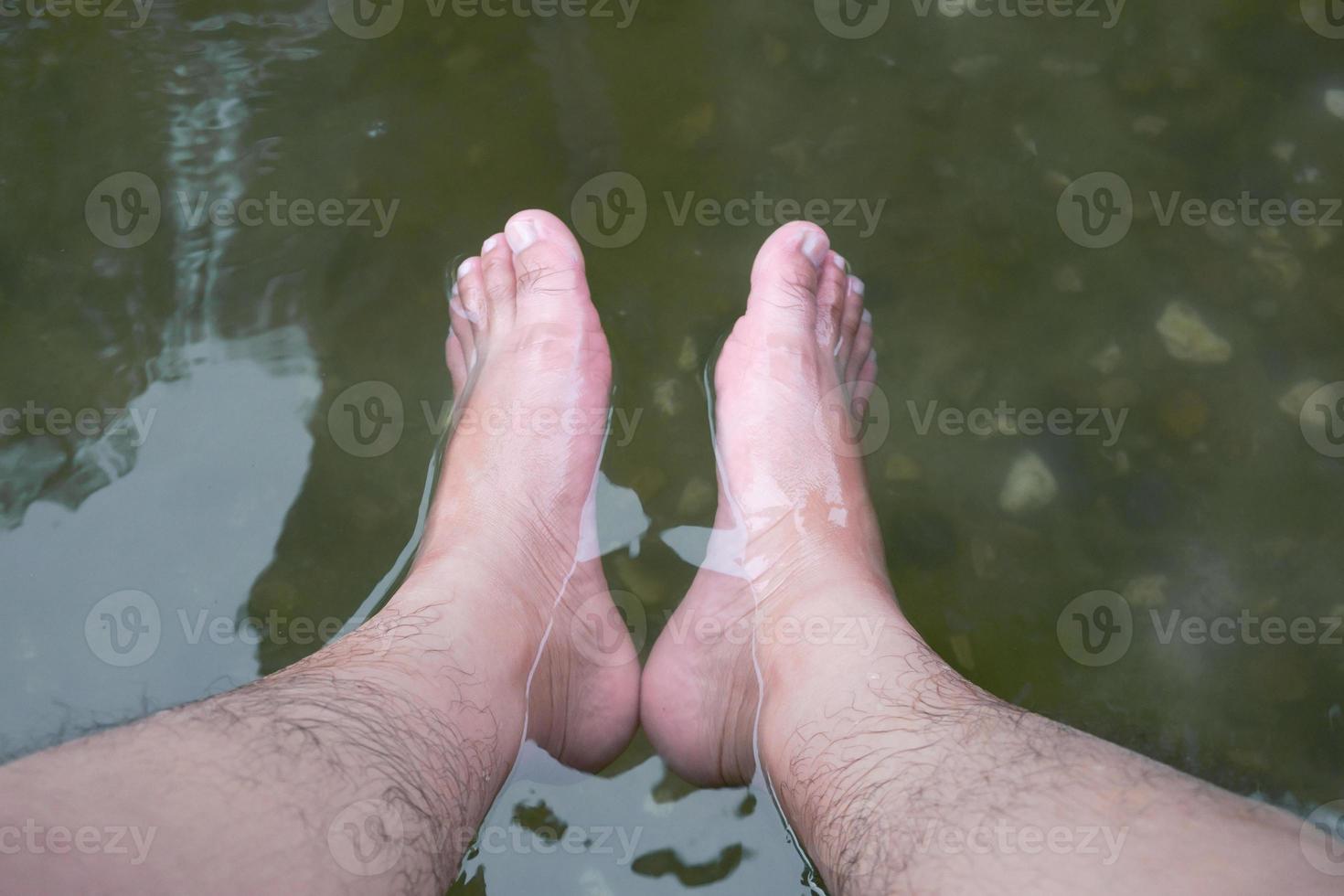 Soaking foot in the water at hot spring foot bath for therapy photo