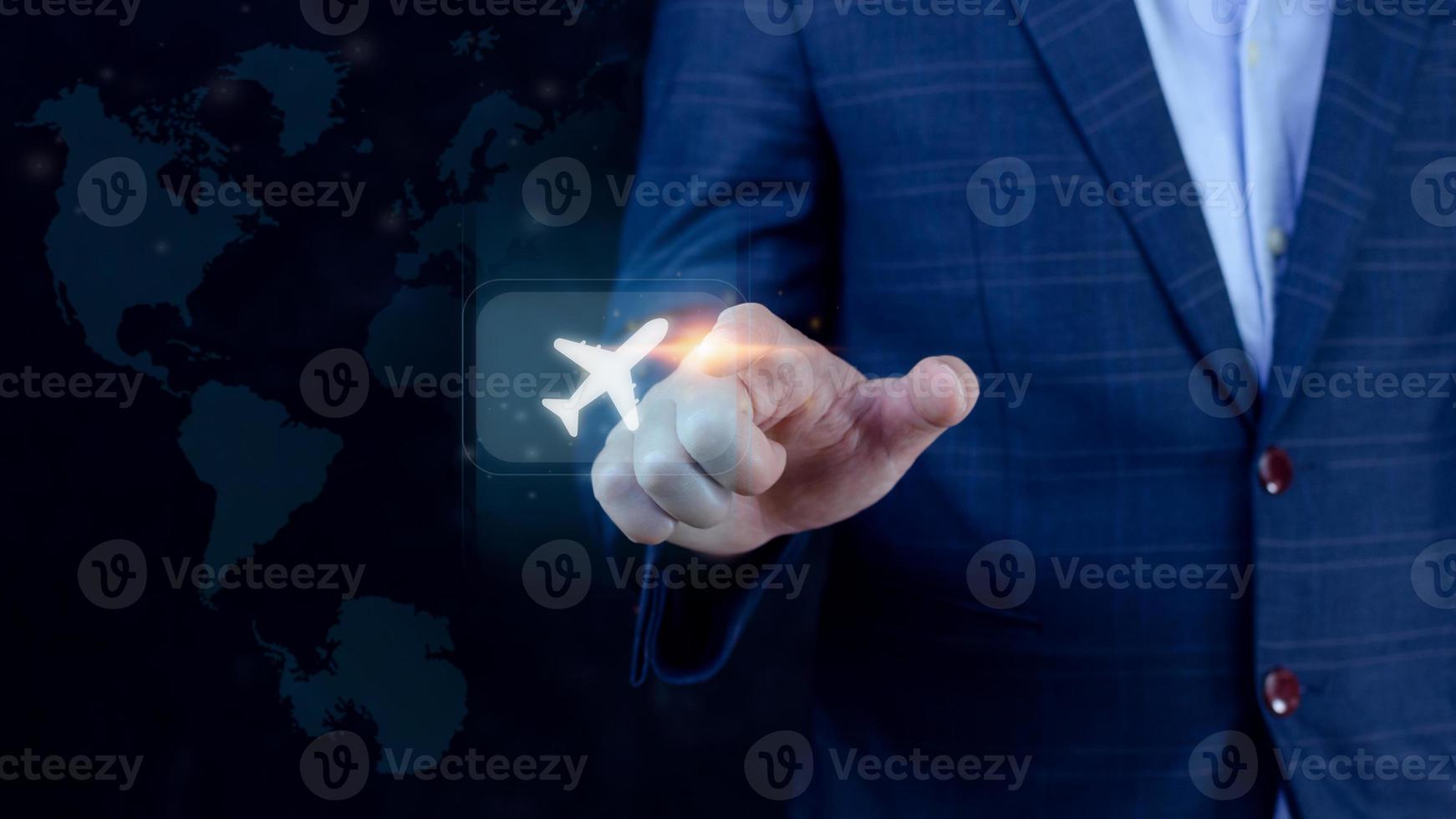 Businessman pointing finger touching to select flight by pressing touch screen airplane button with world map background,Business Airplane transportation concept photo