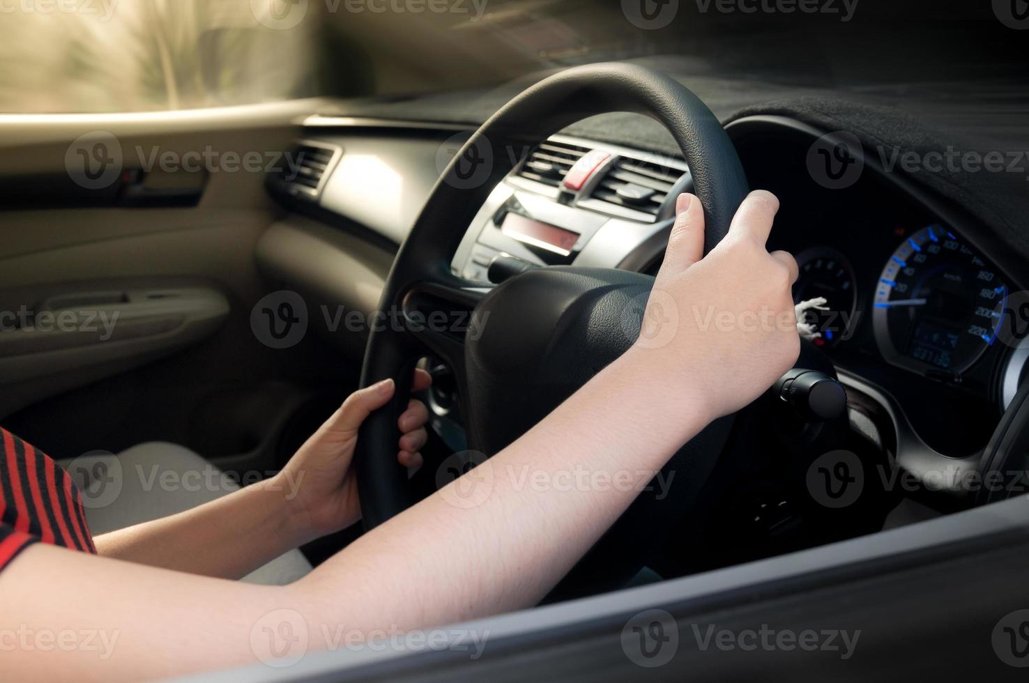 woman hand holding on black steering wheel, woman drive a car photo