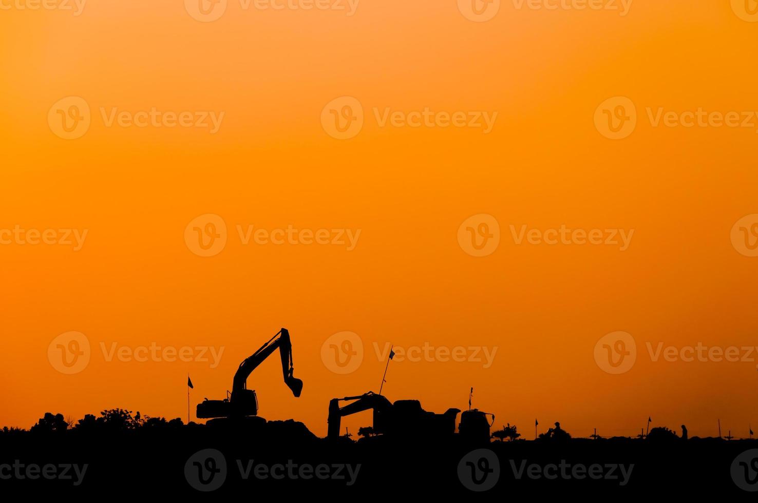 silhouette of excavator loader at construction site,Silhouette Backhoe,track-type loader excavator machine doing earthmoving photo