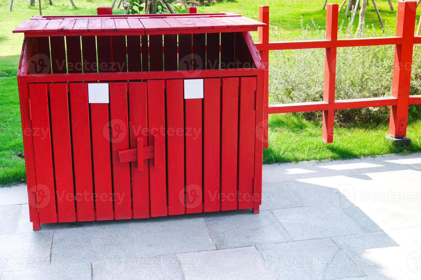 Red trash wood in the park.Containers for separate waste collection. Translation Plastic, Glass, Paper, Unsorted.Trash bins for separate garbage collection. trash container. photo