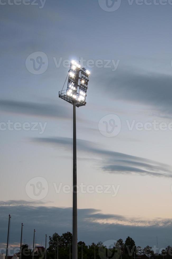 Stadium lights on a sports field at evening with dilapidated photo