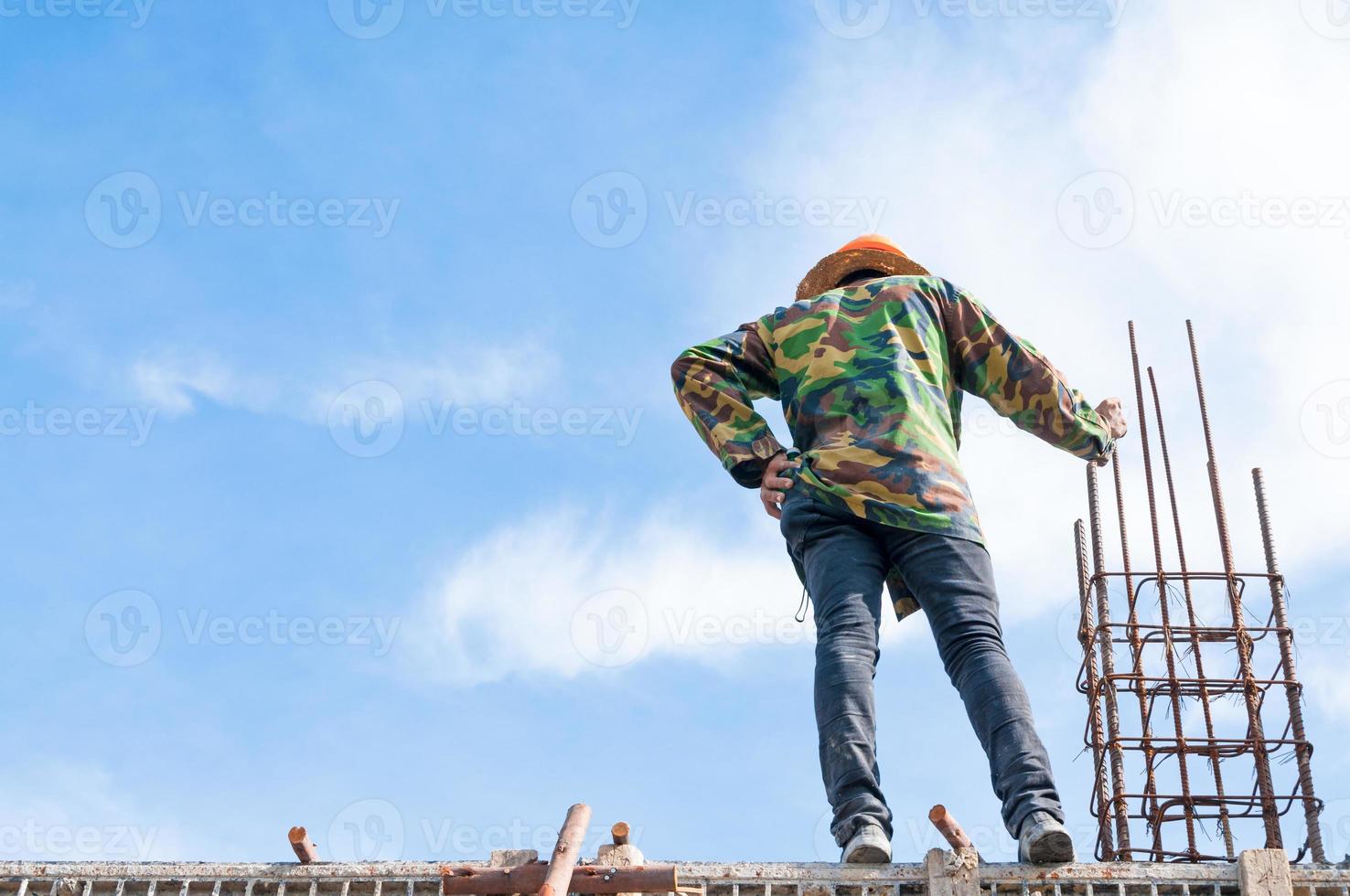 Construction building workers at construction,Man Working at height with blue sky at construction site photo