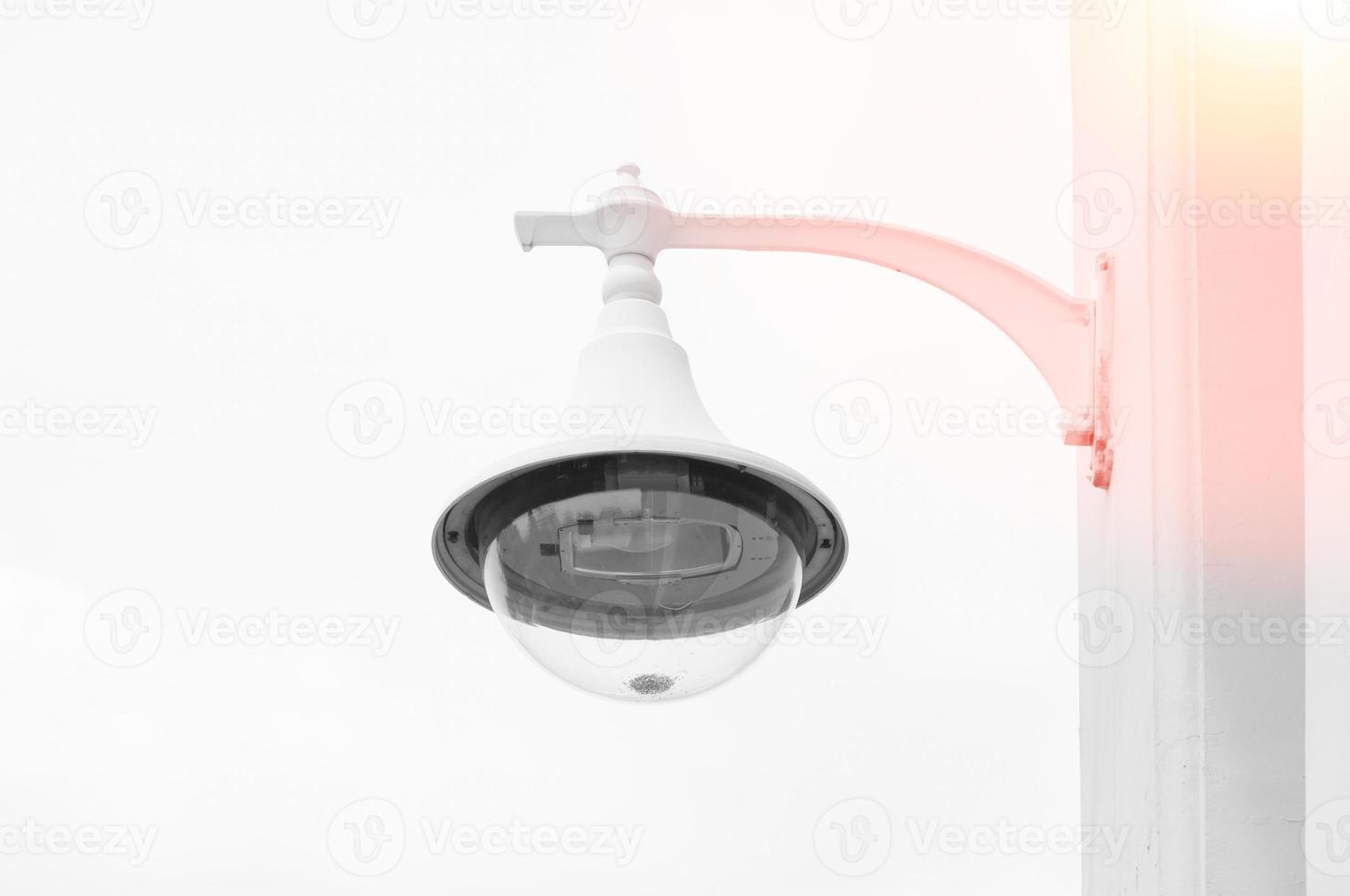 Lamppost on a white background,classic white wall lamp,retro with a lamp shade and a bulb photo
