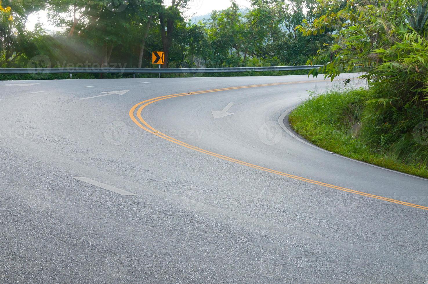 Countryside road with trees on both sides,Curve of the road to mountain photo