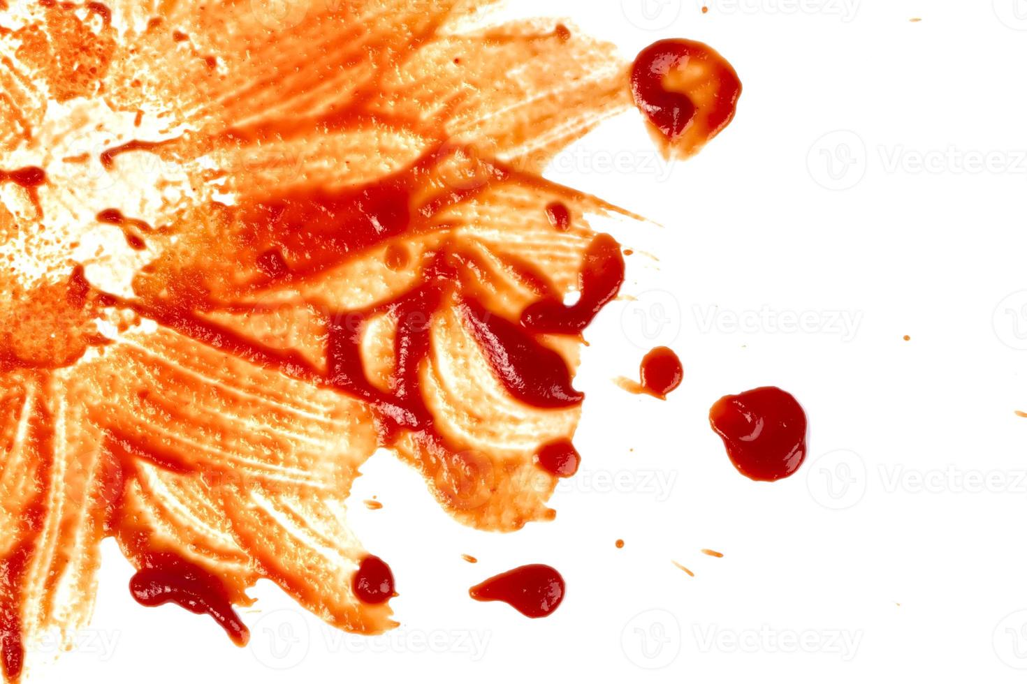 Red stain from ketchup smeared on a white background. photo