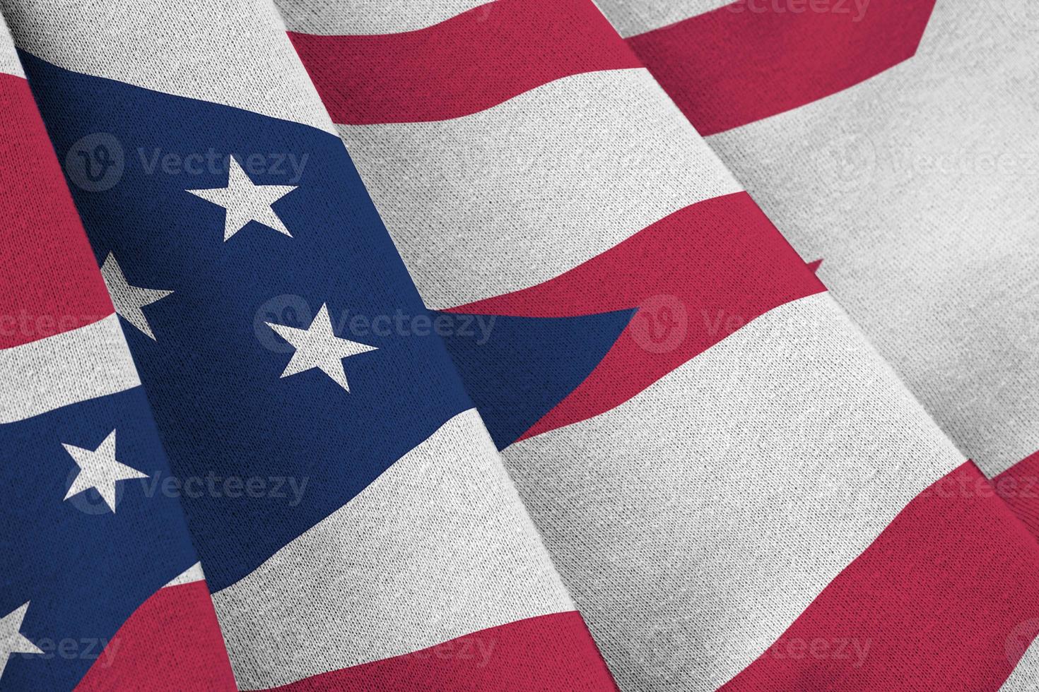 Ohio US state flag with big folds waving close up under the studio light indoors. The official symbols and colors in banner photo