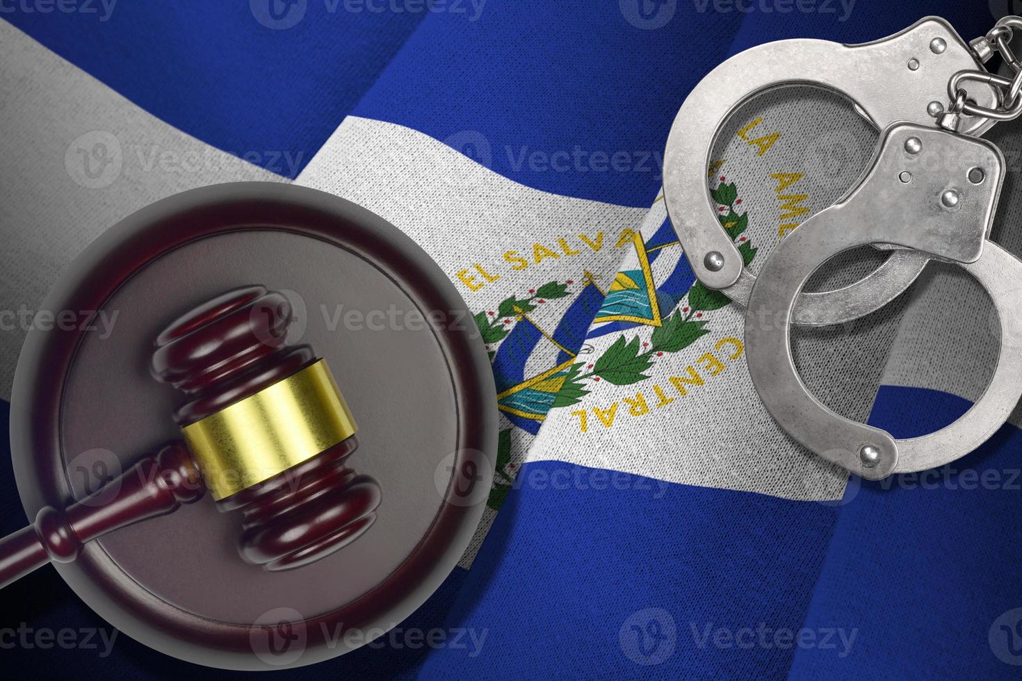 El Salvador flag with judge mallet and handcuffs in dark room. Concept of criminal and punishment, background for judgement topics photo