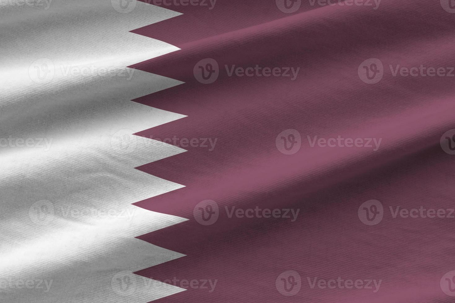 Qatar flag with big folds waving close up under the studio light indoors. The official symbols and colors in banner photo