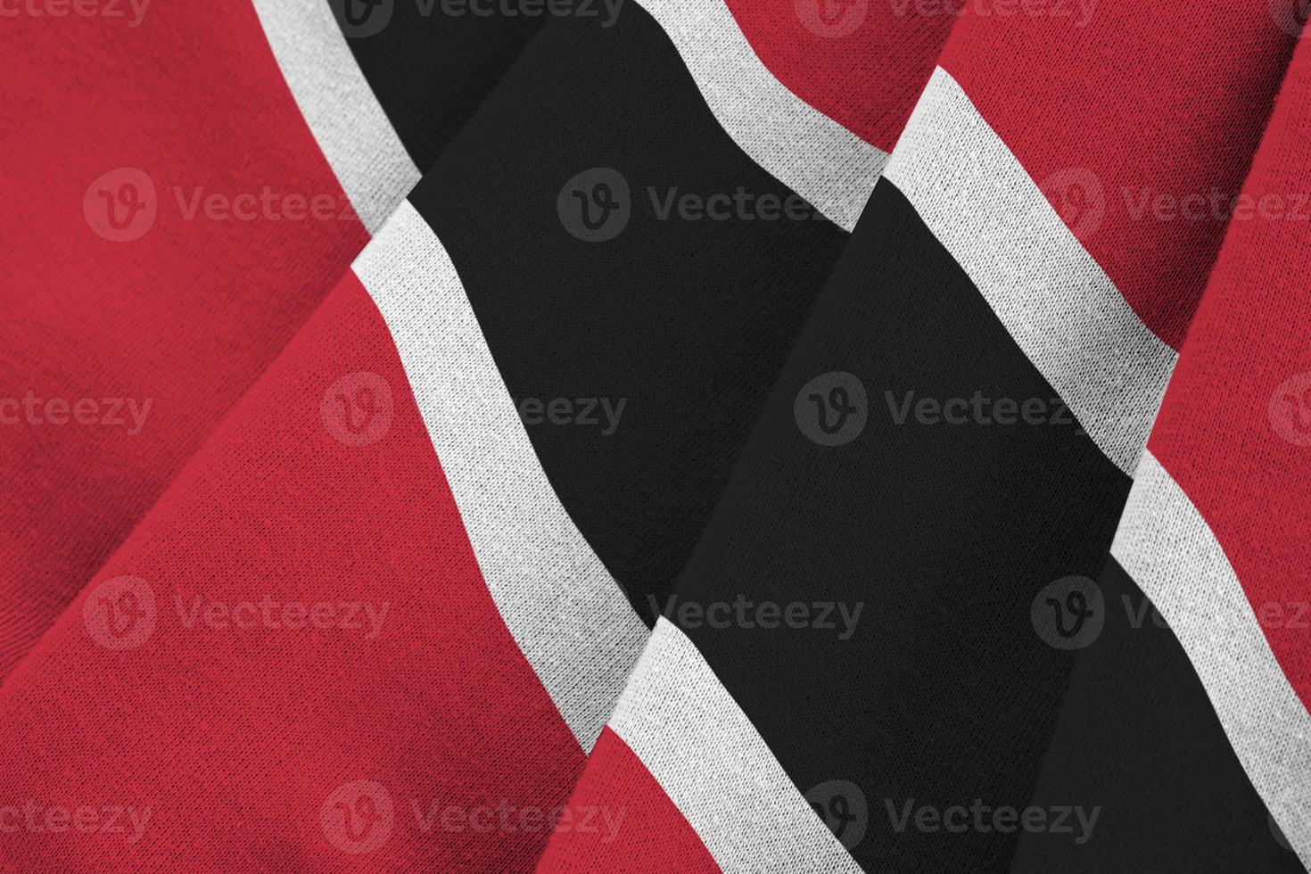 Trinidad and Tobago flag with big folds waving close up under the studio light indoors. The official symbols and colors in banner photo