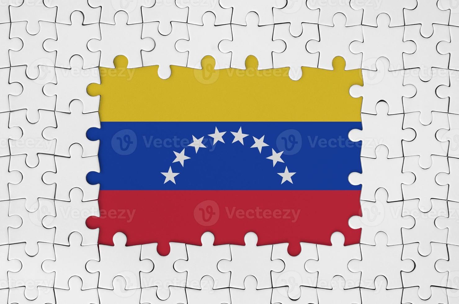 Venezuela flag in frame of white puzzle pieces with missing central part photo