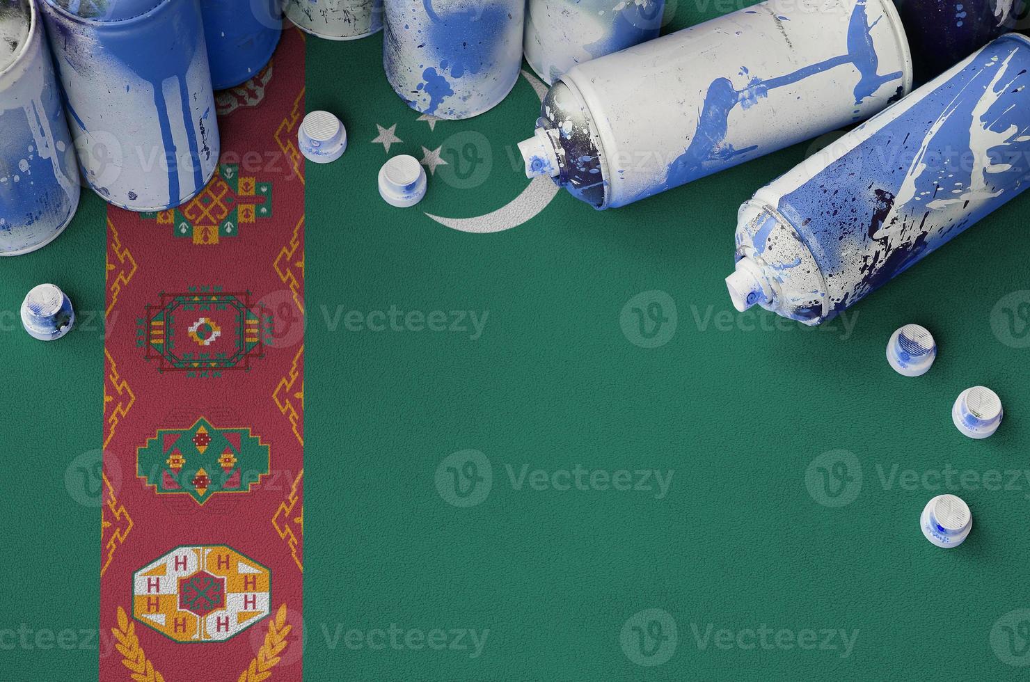 Turkmenistan flag and few used aerosol spray cans for graffiti painting. Street art culture concept photo