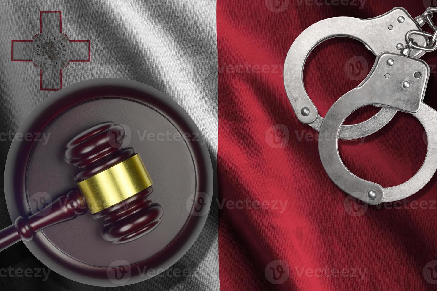 Malta flag with judge mallet and handcuffs in dark room. Concept of criminal and punishment, background for judgement topics photo