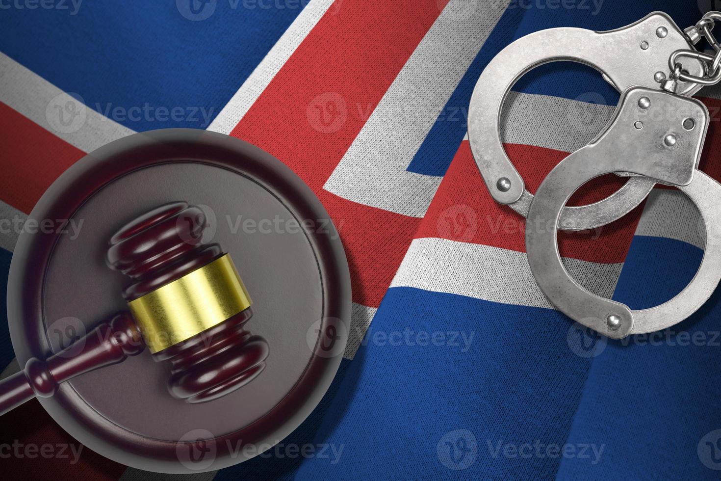 Iceland flag with judge mallet and handcuffs in dark room. Concept of criminal and punishment, background for judgement topics photo