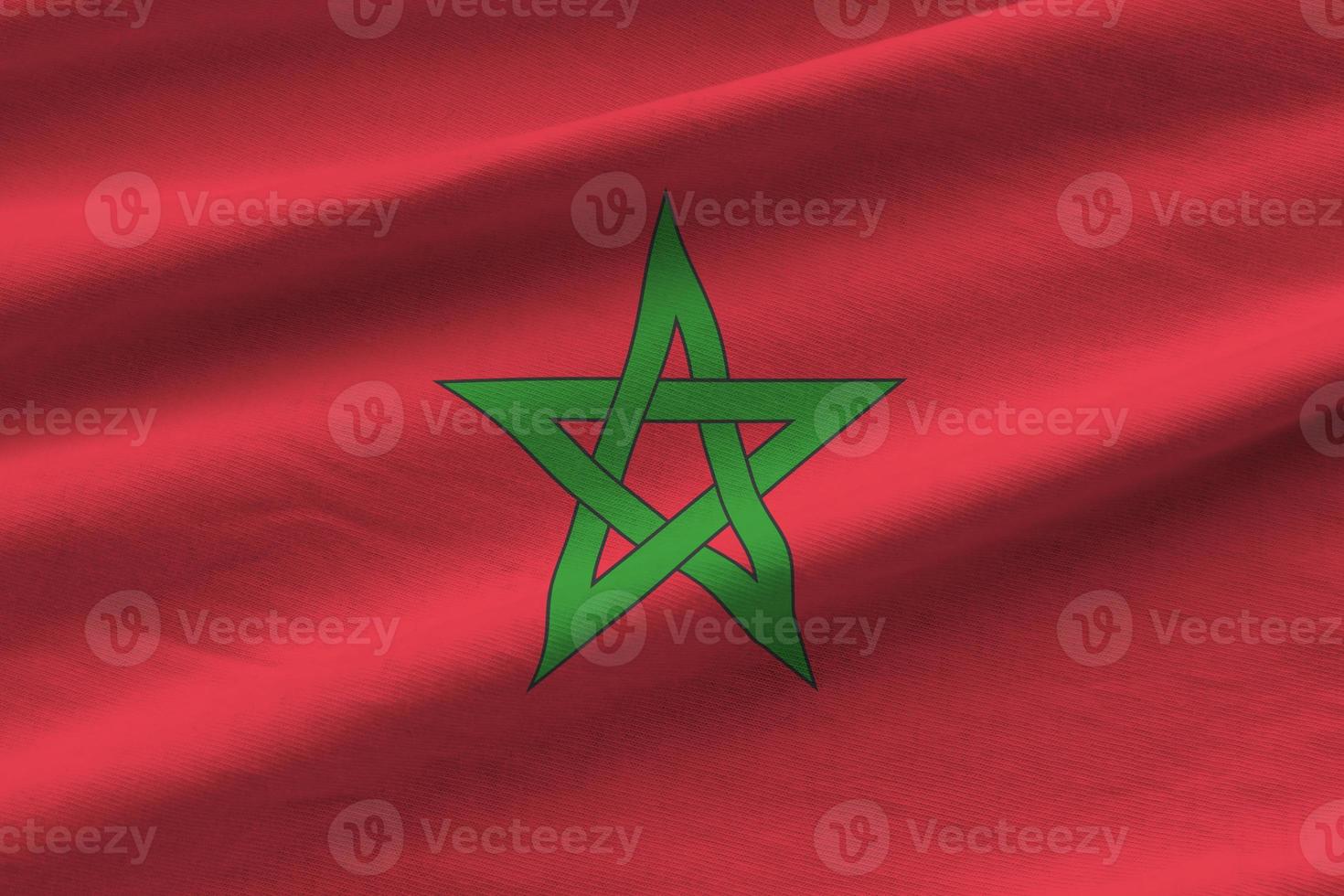 Morocco flag with big folds waving close up under the studio light indoors. The official symbols and colors in banner photo