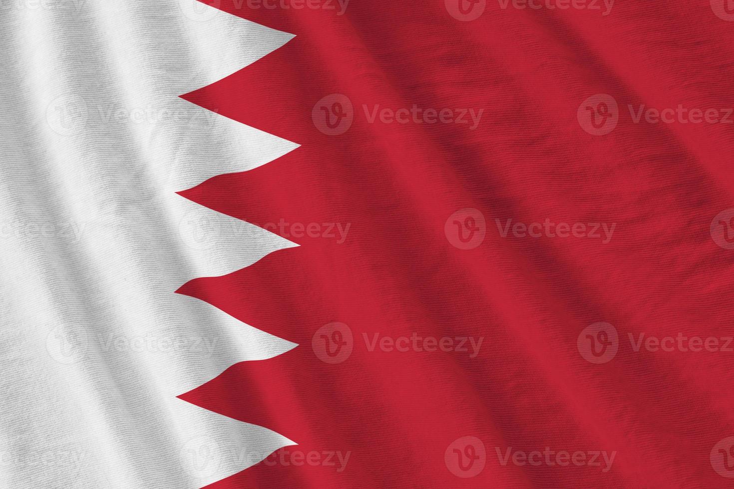 Bahrain flag with big folds waving close up under the studio light indoors. The official symbols and colors in banner photo